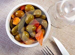 Light snack – oval bowl with pickled vegetables, gherkin and green olives