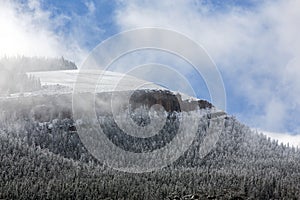 Light snow on Wyoming mountain with clouds