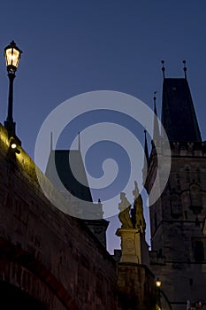 Light of streets light and statue on charles bridge and towers on him.colorful skies at dusk