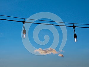 Light string on a summer evening with cloud on the background