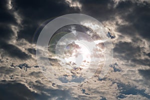 The light of the sun through the thick dark clouds