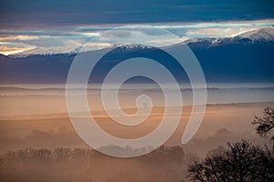 Light from sunsrise with fog and mountains