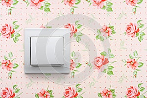 Light switch on floral wallpaper