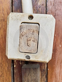 a light switch made of plastic that functions to turn on or turn off the light
