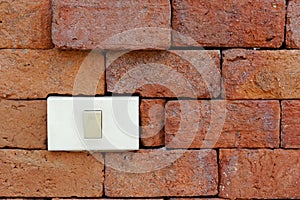 Light switch on red brick wall