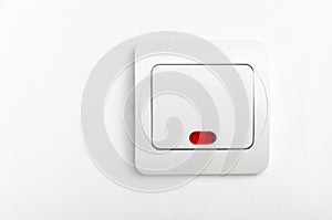 Light switch with red led on white wall