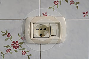 light switch and schuko, on the wall that powers light points or appliances in the house via an extension cord.