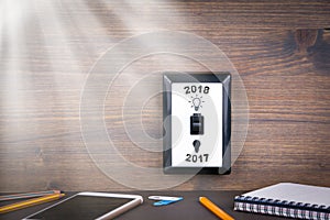 Light switch is switched from 2017 to 2018. New Year`s Business and Opportunity Background