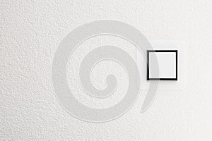 Light switch on white wall, detail shot