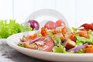 Light tasty salad with meat of a cancer, shrimps, lettuce, garlic croutons, tomatoes