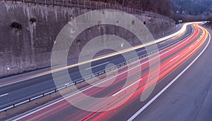 Light trail of white Headlights and red Backlights of cars on highway, taken with long-term exposure. Traffic and speed