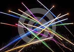 Light trails against a black background create a dynamic, starburst-l