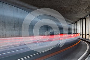 Light trails of car driving through at tunnel