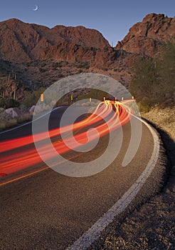 Light trails from cars on a desert road