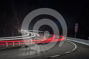 Light trails of cars. moving  on curve street at night