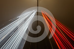 Light trails on the highway at a foggy night