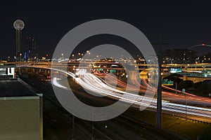 Light trails on highway I-35 in Dallas with Reunion Tower