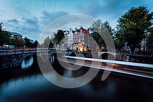 Light trails at the Leidsegracht and Keizersgracht canals in Amsterdam at dusk. Long exposure shot