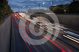 Light trails from speeding cars on the A40 highway in Perivale, London, UK, during the early evening