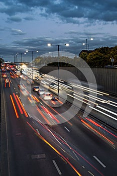 Light trails from speeding cars on the A40 highway in Perivale, London, UK, during the early evening