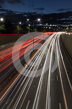 Light trails from speeding cars on the A40 highway in Perivale, London, UK, during the early evening