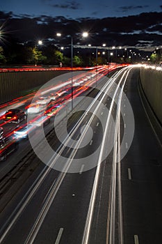 Light trails from speeding cars on the A40 highway in Perivale, London, UK, during the early evening