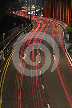 Light trails of traffic on road at night. Transportation background