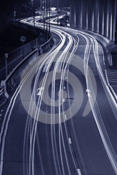 Light trails of traffic on road at night. Transportation background