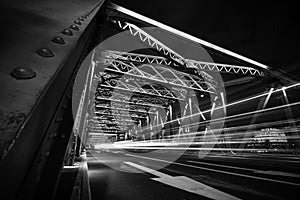 Light trails of traffic on steel bridge at night