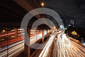 Light trails on urban street and bridge at night