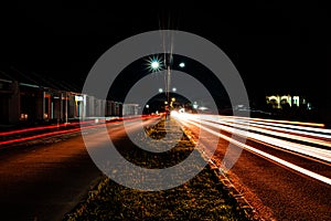 Light trails from vehicles crossing two lanes in serang