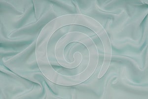 Light turquoise satin material, blue sateen fabric, silk textile photo