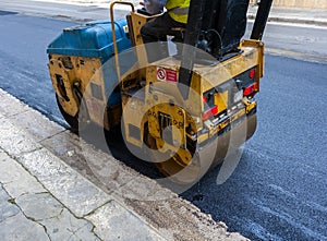 Light vibration roller compactor at asphalt