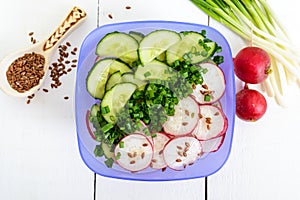 A light vitamin spring - summer salad with fresh cucumbers, radish