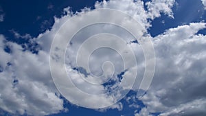 Light white clouds fly across a bright blue sky. Clear sky at sunny summer afternoon. Spring cloudscape background. Copy space