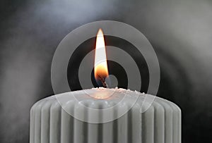 Light the wick of a candle with a match