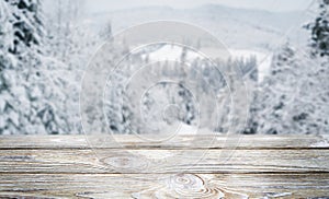 Light wooden background with snowy mountains.