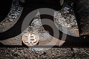 Light wooden bit coin on a steal rusty fence