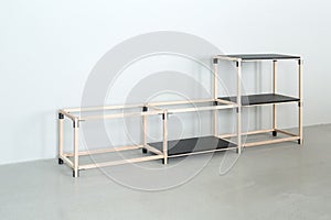 Light wooden construct with black tabletops