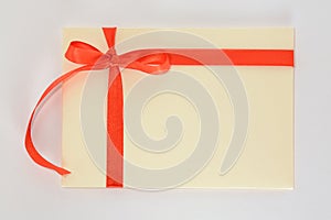 Light yellow envelope with a red ribbon on a white background