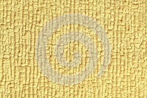 Light yellow fluffy background of soft, fleecy cloth. Texture of textile closeup.