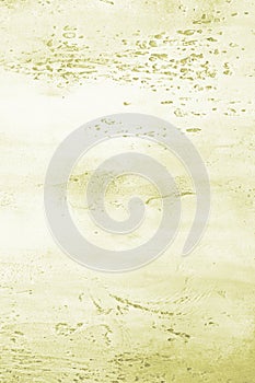 Light yellow green textured concrete background with light base darker in the recesses. Abstract texture for graphic design or