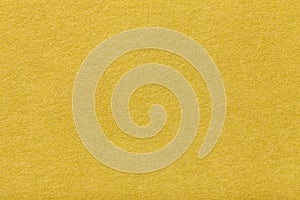 Light yellow matt suede fabric closeup. Velvet texture of felt.