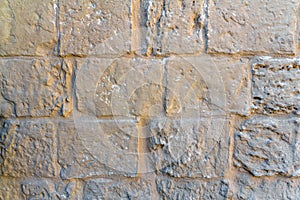 Light yellow stone wall of bricks texture background