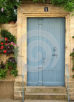 Lightblue wooden door in traditional wall