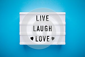 Lightbox on blue background: live, laugh, love