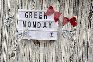 Lightbox with Green Monday text, crafting gift box, Christmas festive decorations. Concept of online shopping. View from