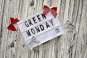 Lightbox with Green Monday text, crafting gift box, Christmas festive decorations. Concept of online shopping. View from