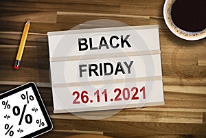 Lightbox or light box with business equipment and black friday with wooden table background