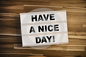 Lightbox or light box with message Have a nice day on a wooden table